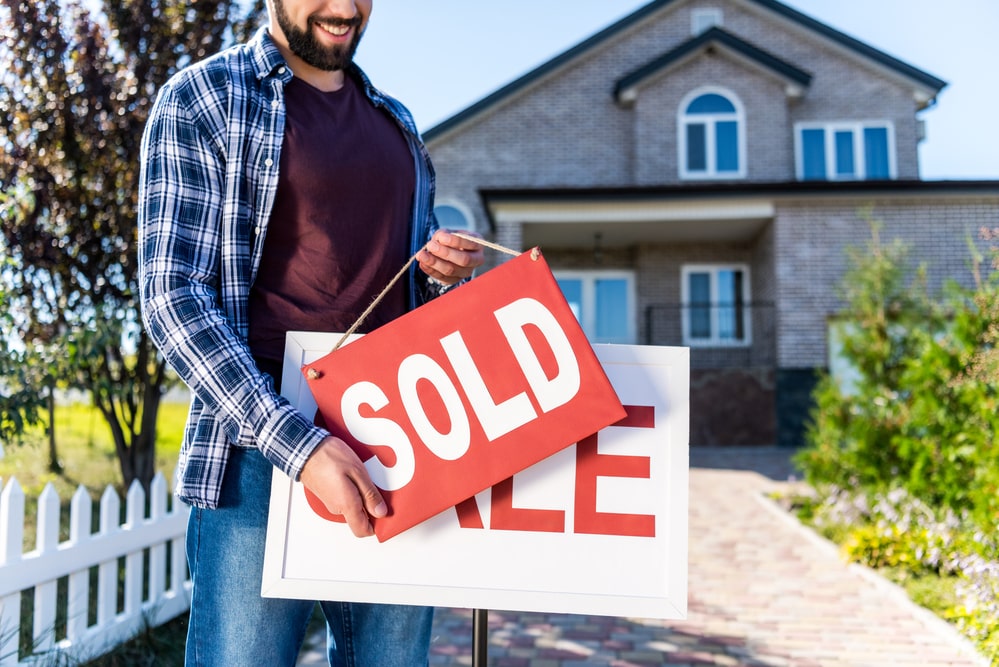 man holding sold sign southern maryland